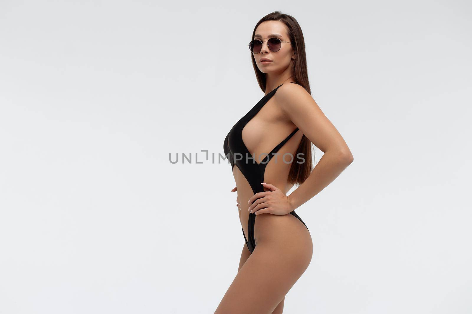 Stylish model in sexy swimsuit and sunglasses by 3KStudio