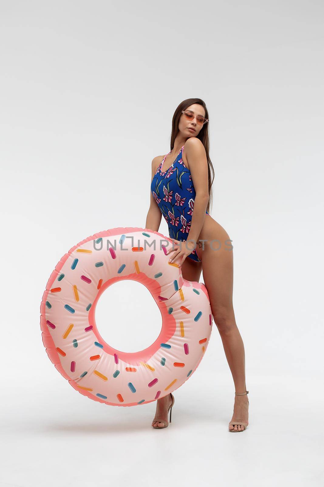 Seductive woman in swimwear with inflatable ring by 3KStudio