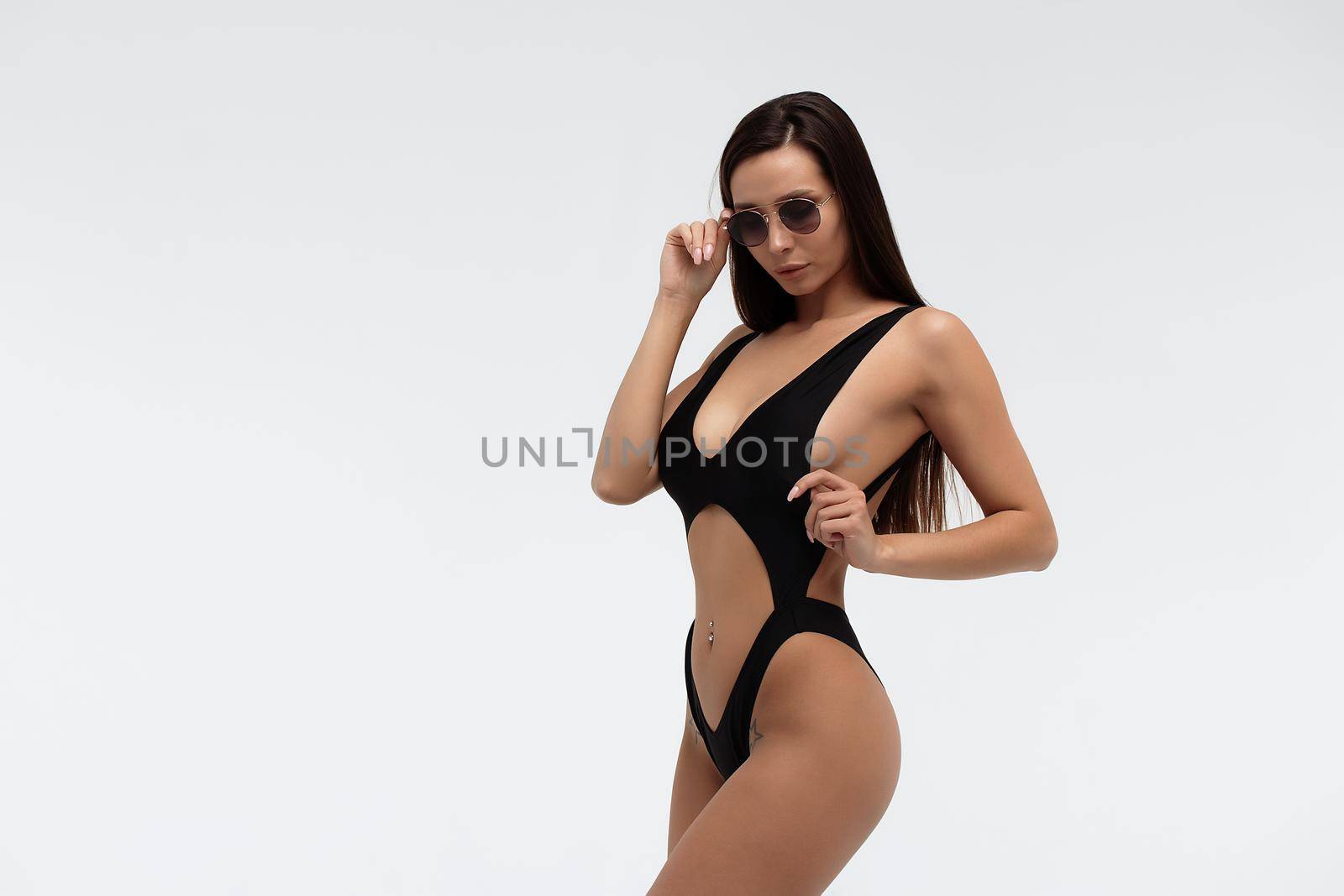 Sexy slim model in stylish black swimsuit by 3KStudio