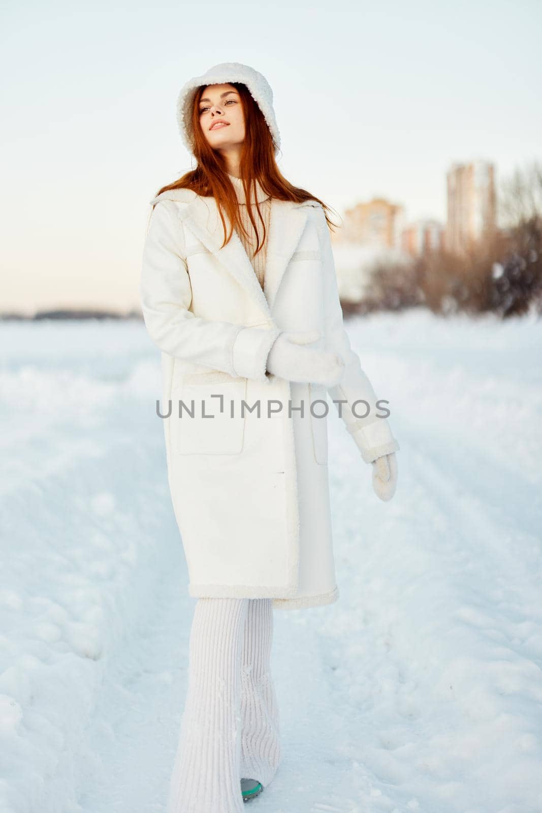 beautiful woman in a white coat in a hat winter landscape walk Lifestyle by SHOTPRIME