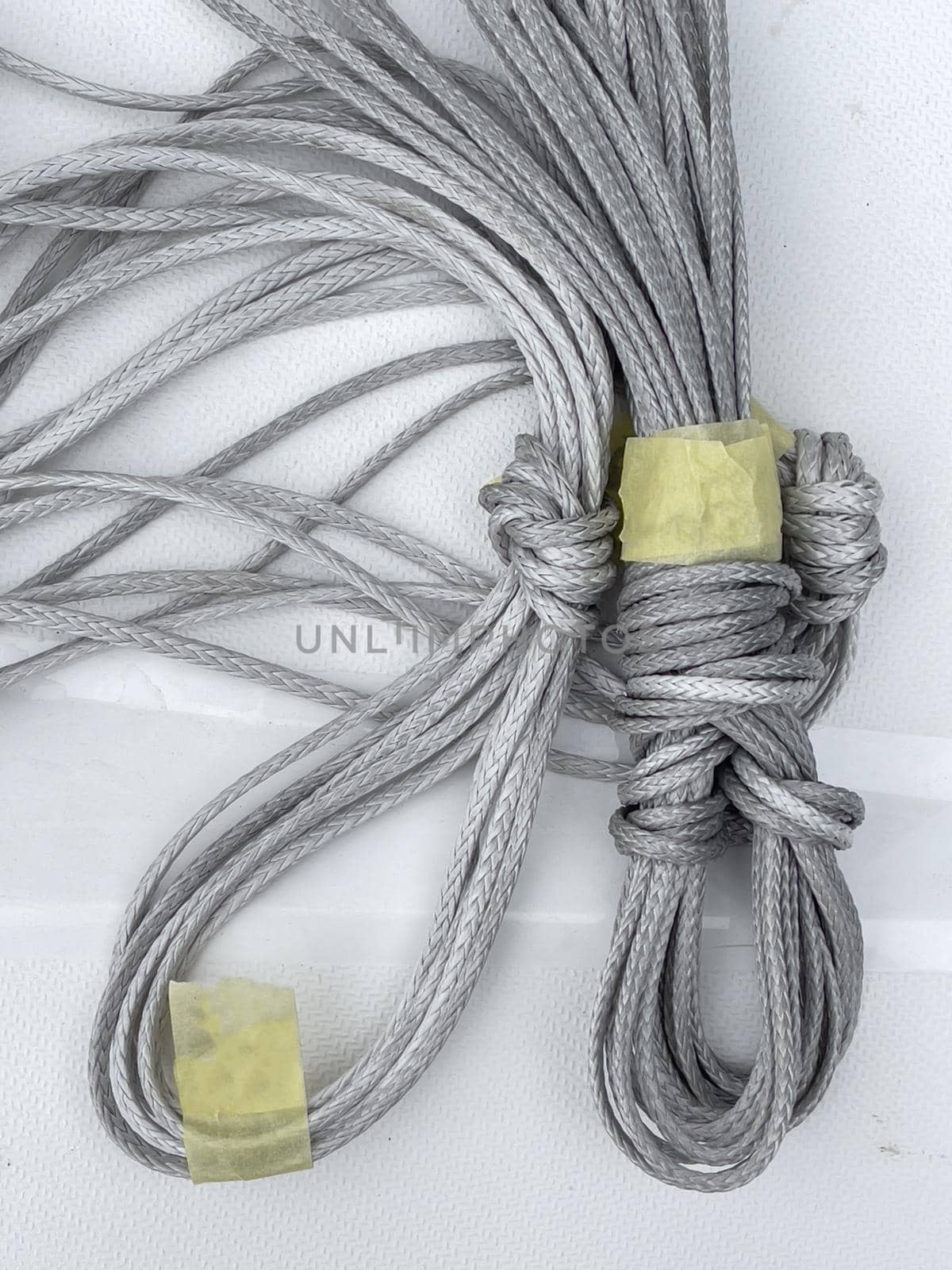 Close-up view of set of ship equipment, ropes for management of the sailboat of different color, yachting sport, the signature to each rope, rollers, carbines, clamps. High quality photo