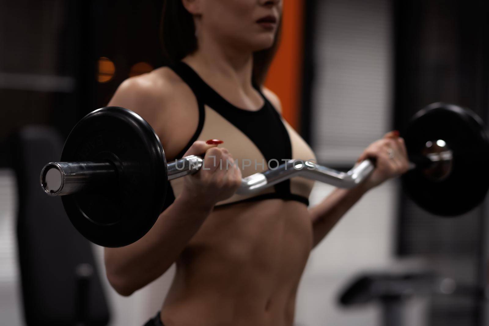 Sporty woman warming up and training in gym by 3KStudio