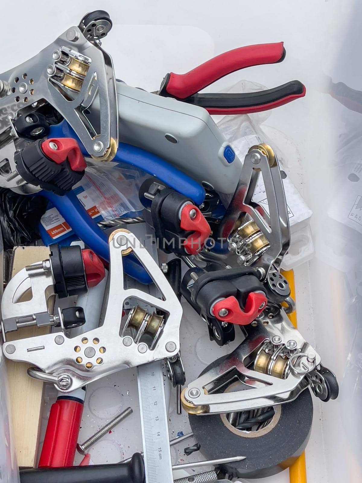 Close-up view of set of ship equipment, ropes for management of the sailboat of different color, pulleys and ropes, yachting sport, the signature to each rope, rollers, levers, carbines, clamps. High quality photo