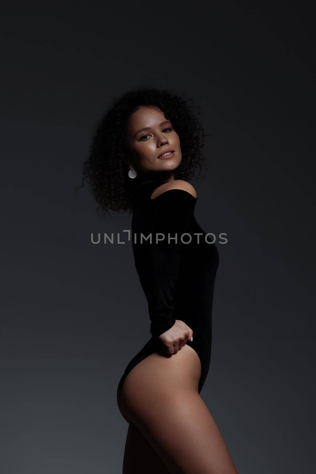 Voluptuous woman in underwear standing gracefully in studio by 3KStudio