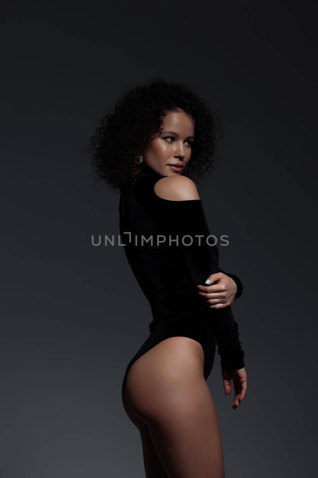 Voluptuous woman in underwear standing gracefully in studio by 3KStudio