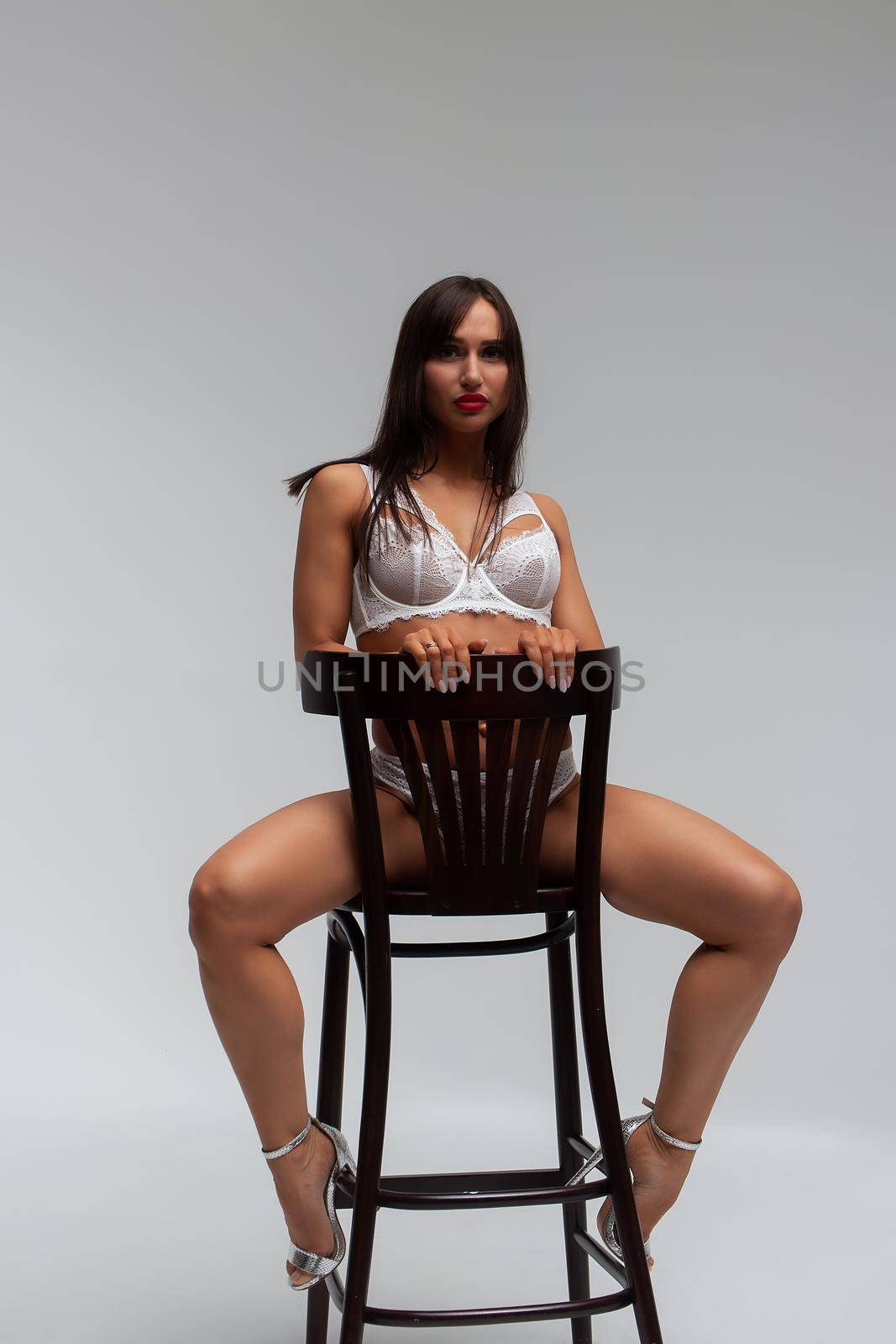 Slim woman in lingerie in studio by 3KStudio