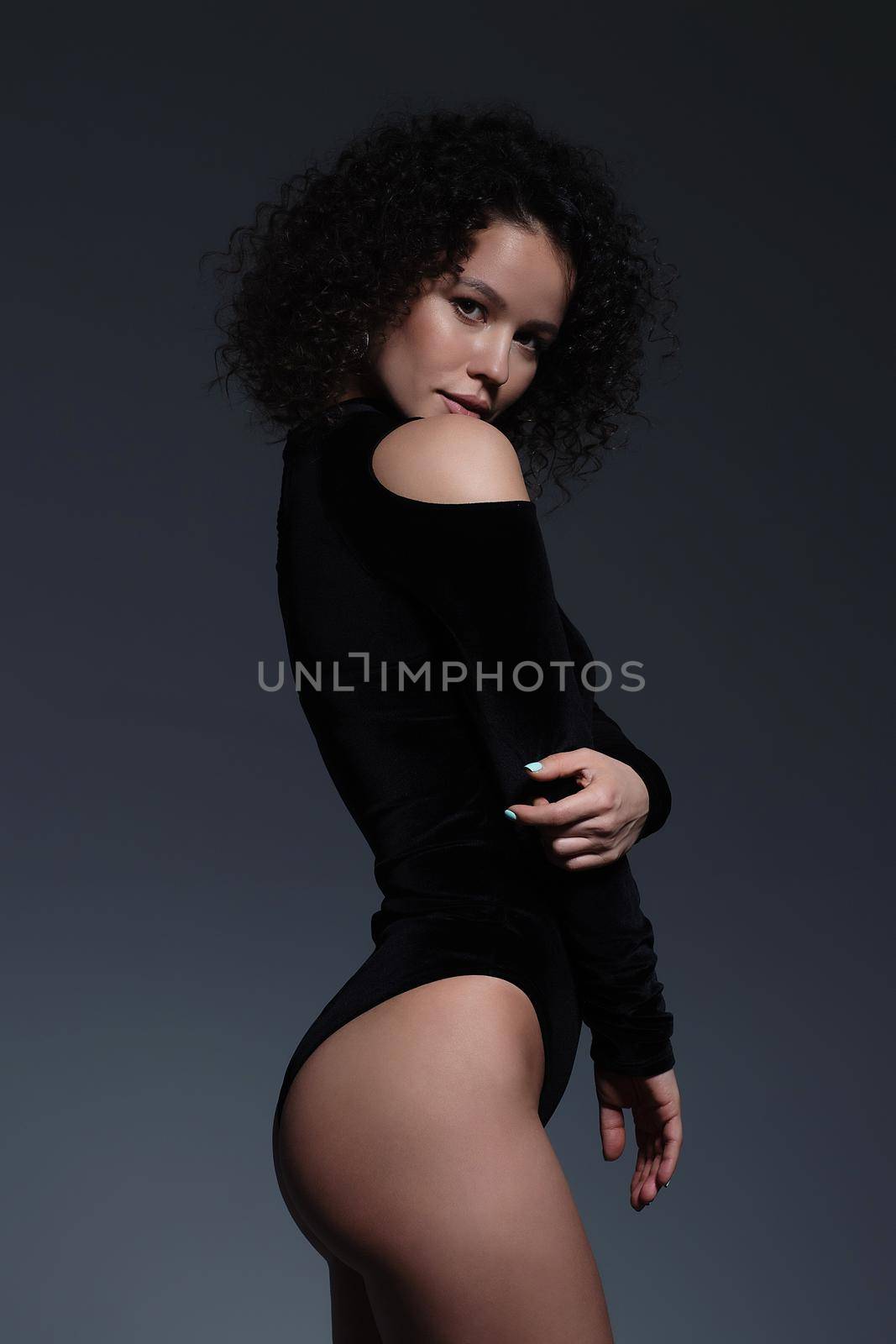 Voluptuous woman in underwear standing gracefully in studio by 3KStudio