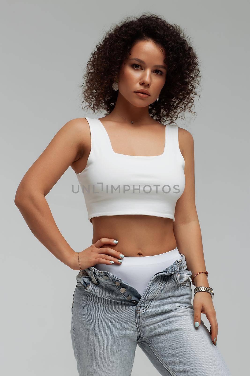 Stylish curly haired woman in denim outfit by 3KStudio