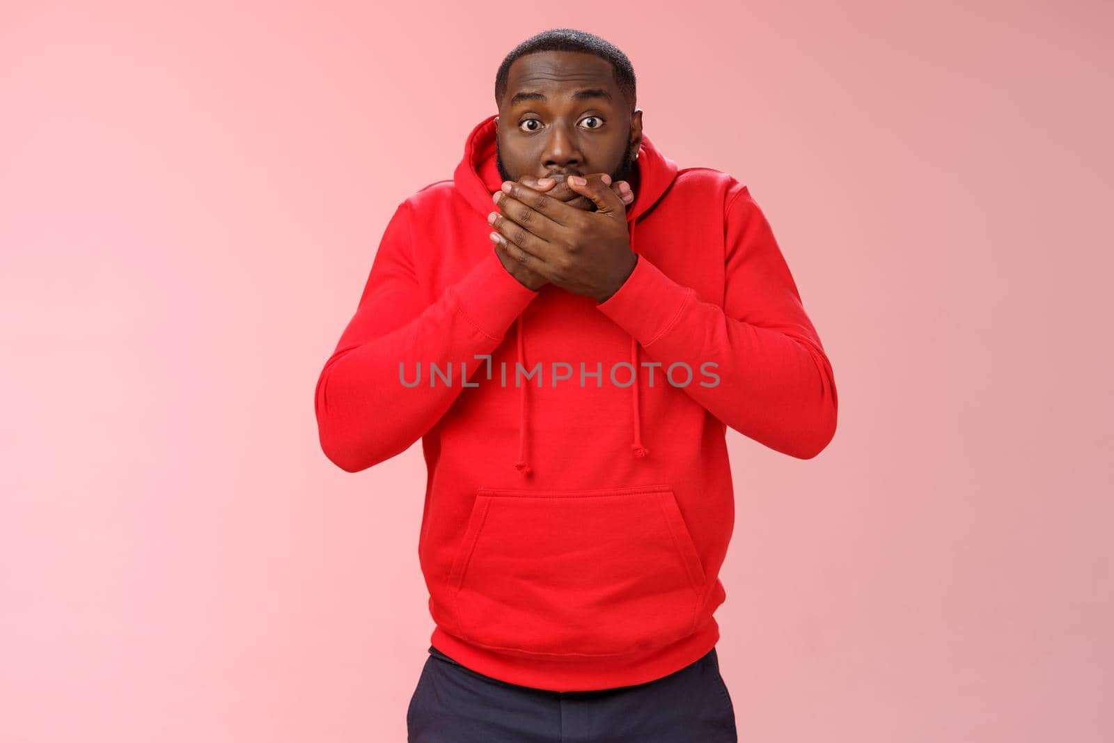 Shocked gasping surprised african-american guy overhear stunning rumour press palms mouth not slip word widen eyes impressed stunned unbeliavable amazing gossip, standing pink background by Benzoix