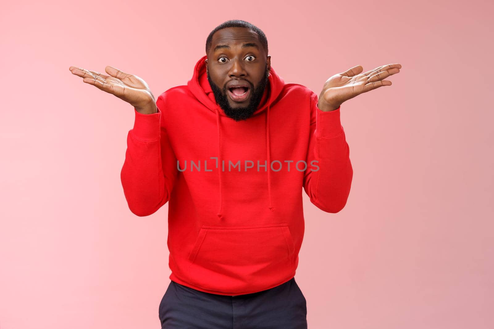 Excited passionate emotive african-american male discussing shocking match moment retelling amusing story cannot get clue how team lost shrugging hands spread sideways dismay look confused by Benzoix