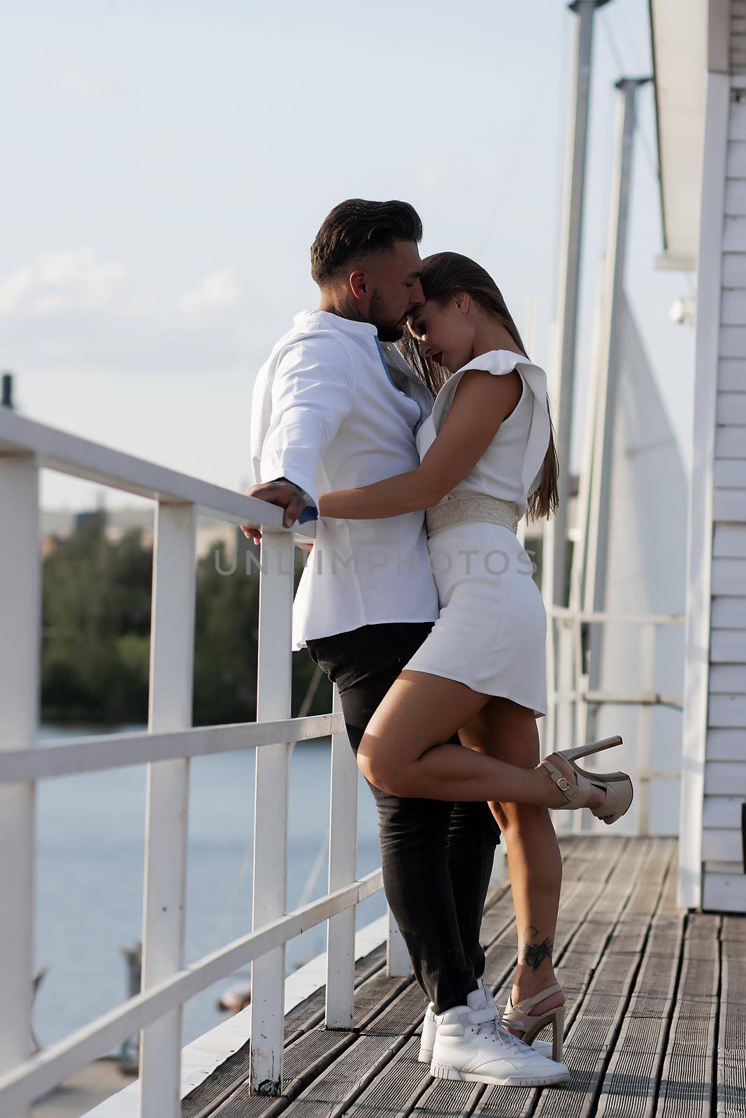 Couple standing in port in summer by 3KStudio