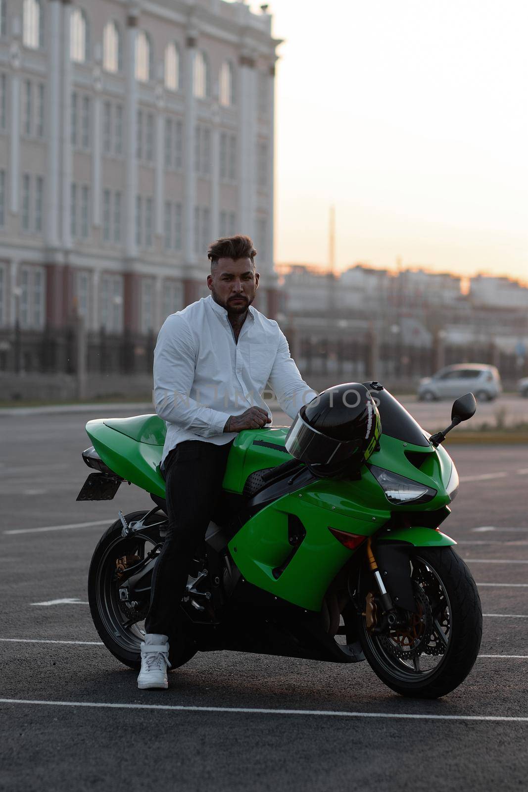 Stylish man on motorbike in evening by 3KStudio