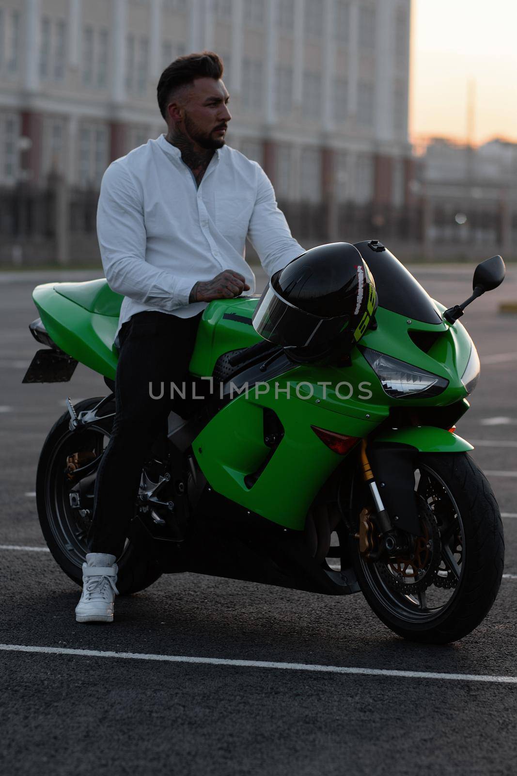 Stylish man on motorbike in evening by 3KStudio