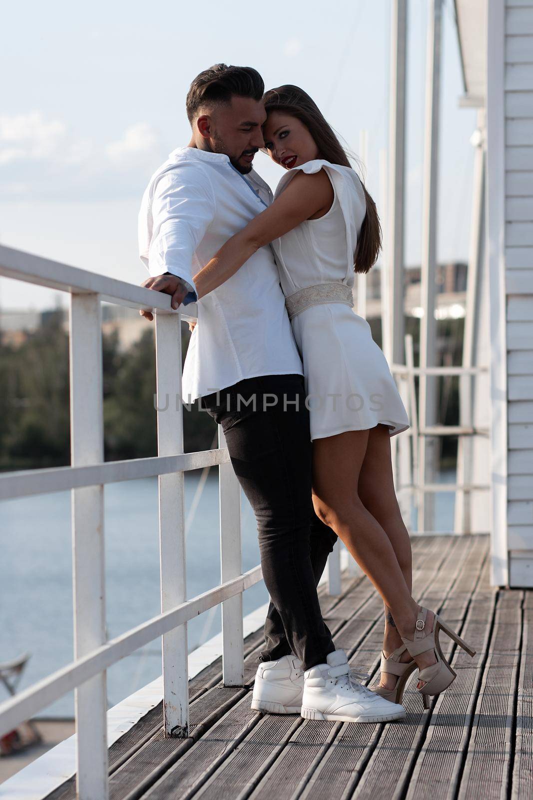 Happy stylish couple hugging in harbor by 3KStudio