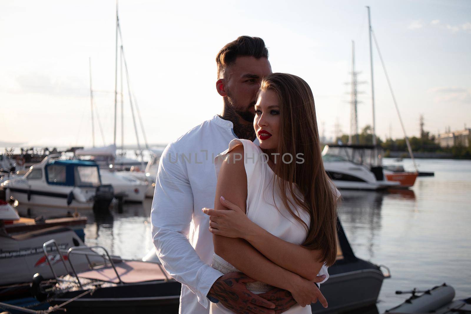 Couple standing in port in summer by 3KStudio
