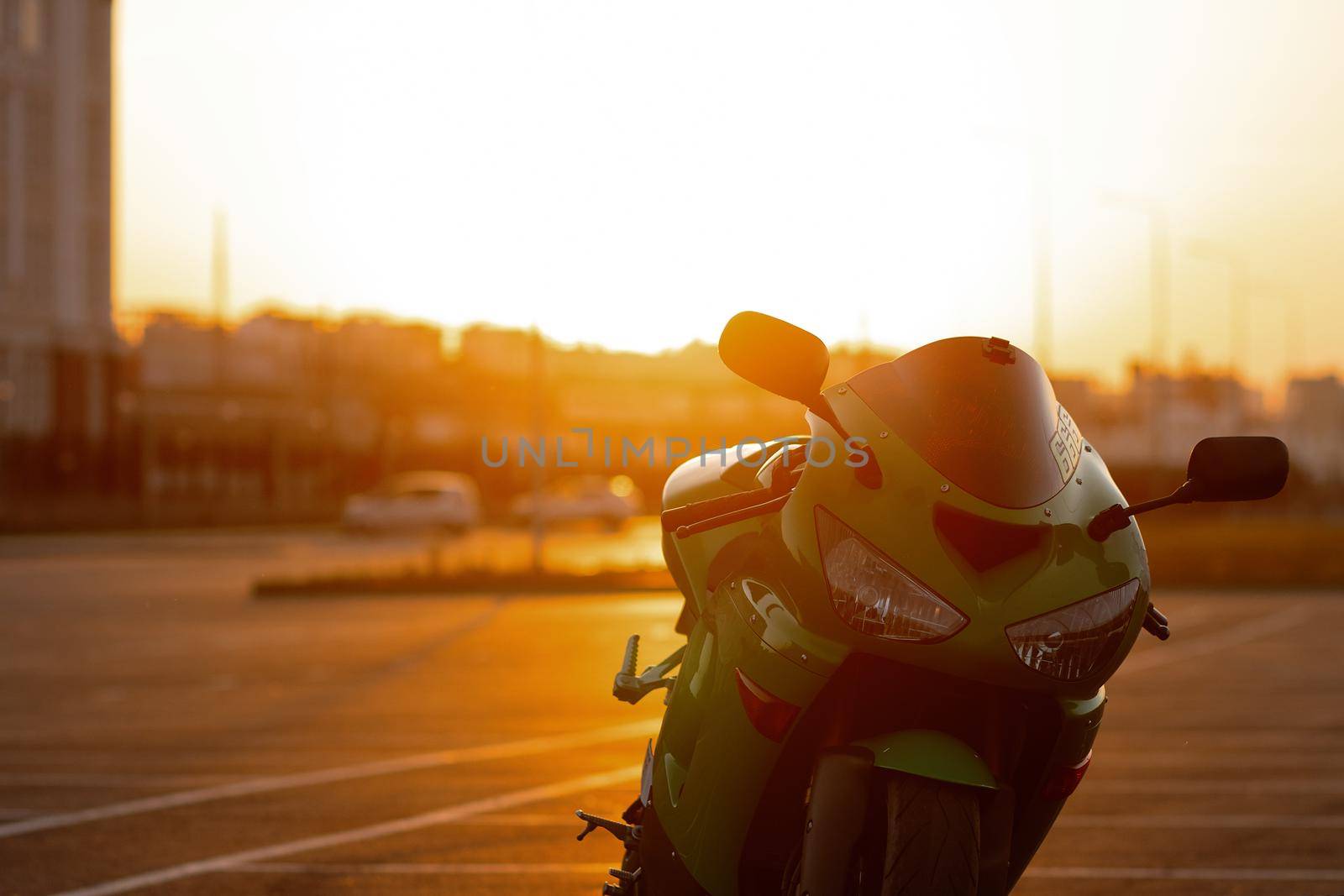 Cool man on motorcycle against sundown sky by 3KStudio