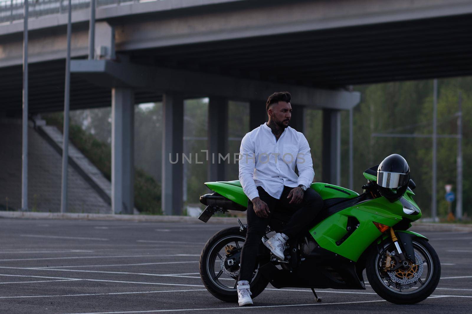 Stylish man on motorbike in evening by 3KStudio