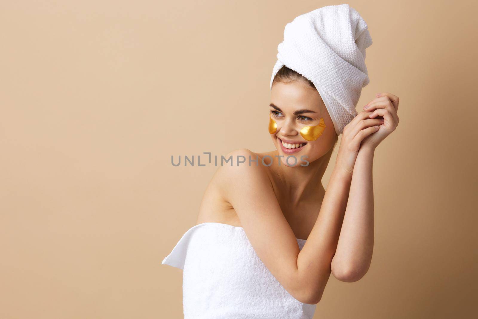 pretty woman golden patches on the face with a towel on the head close-up Lifestyle. High quality photo