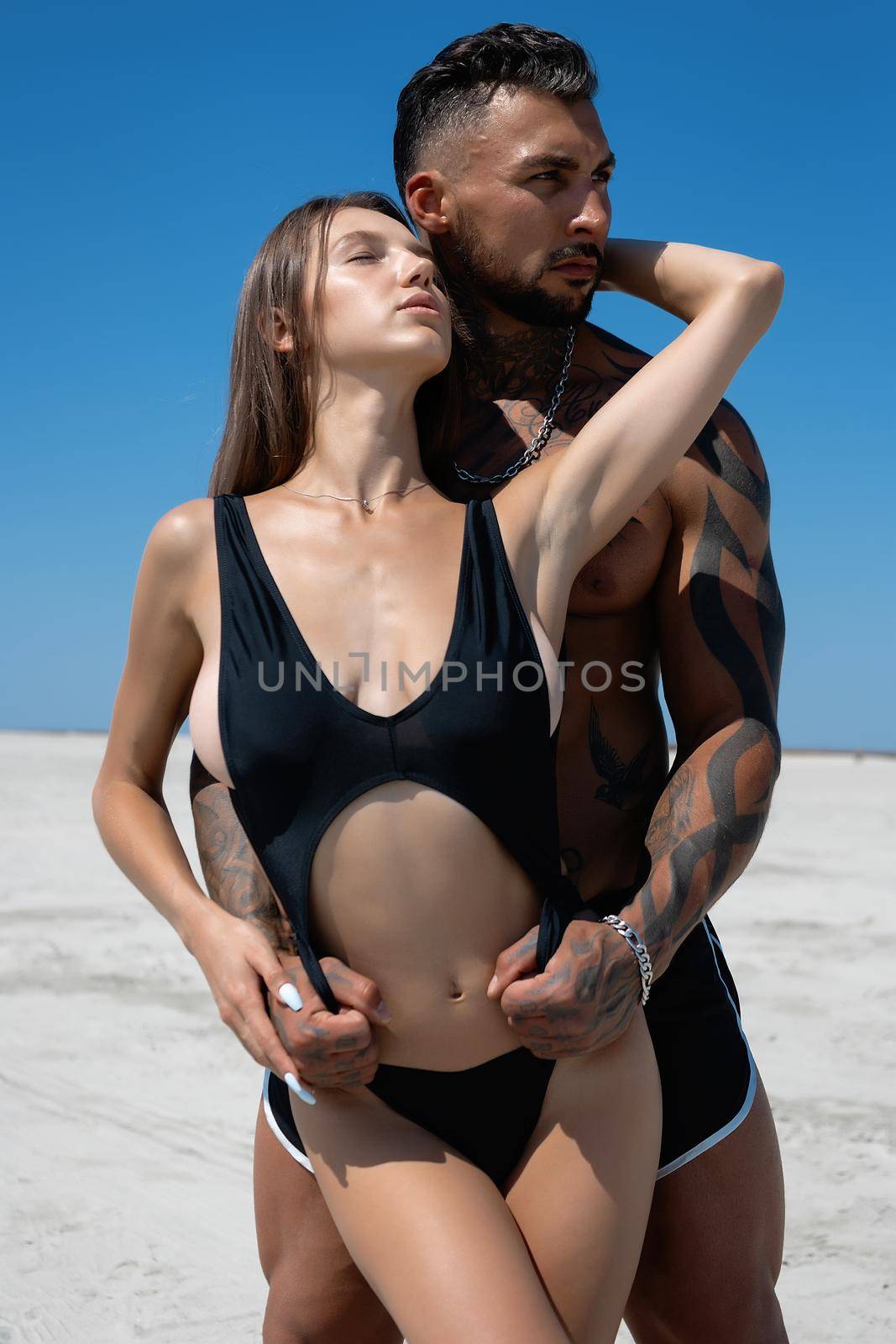 Sexy couple embracing on beach in summer by 3KStudio