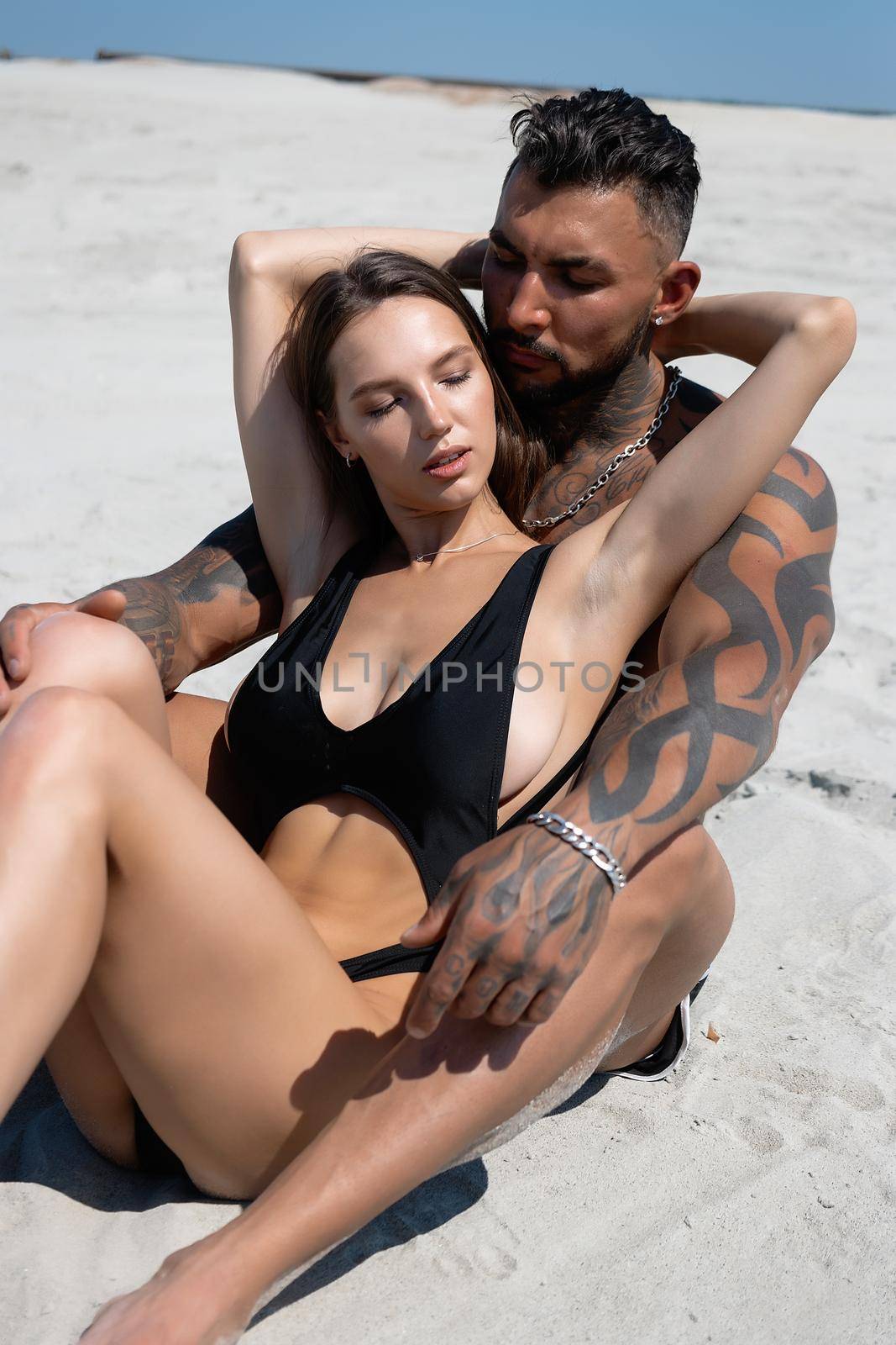 Sexy couple embracing on beach in summer by 3KStudio