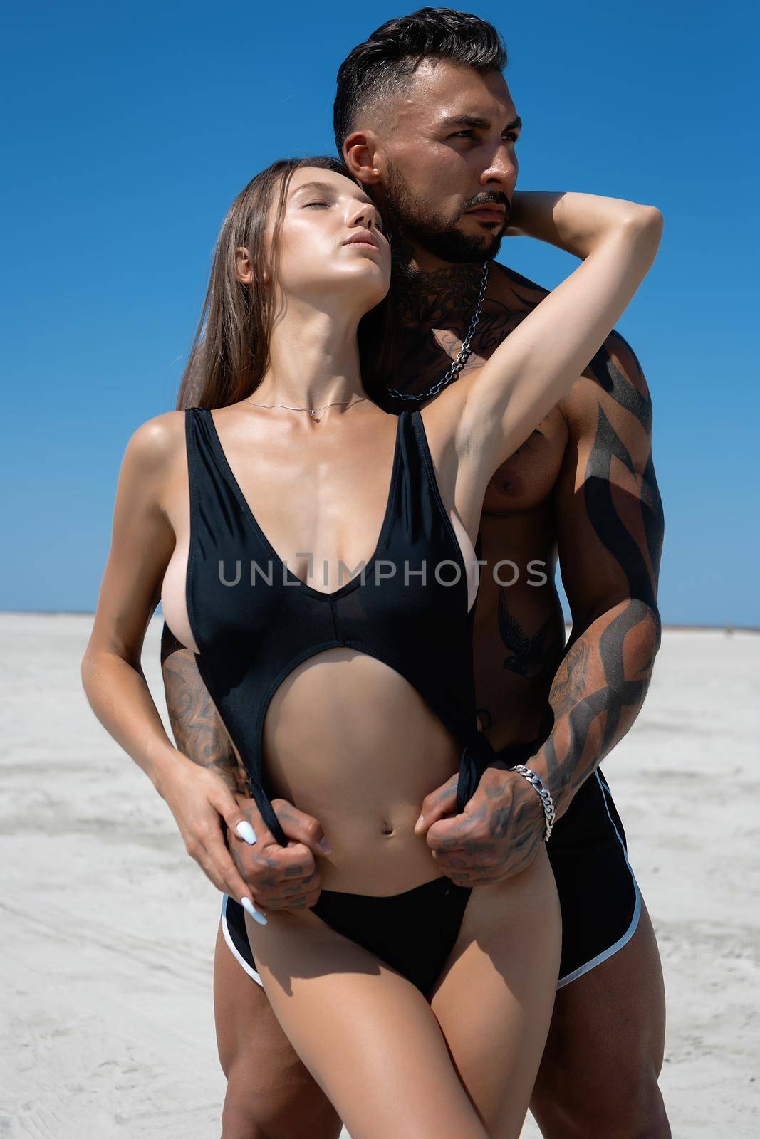 Sexy couple embracing on beach in summer by 3KStudio