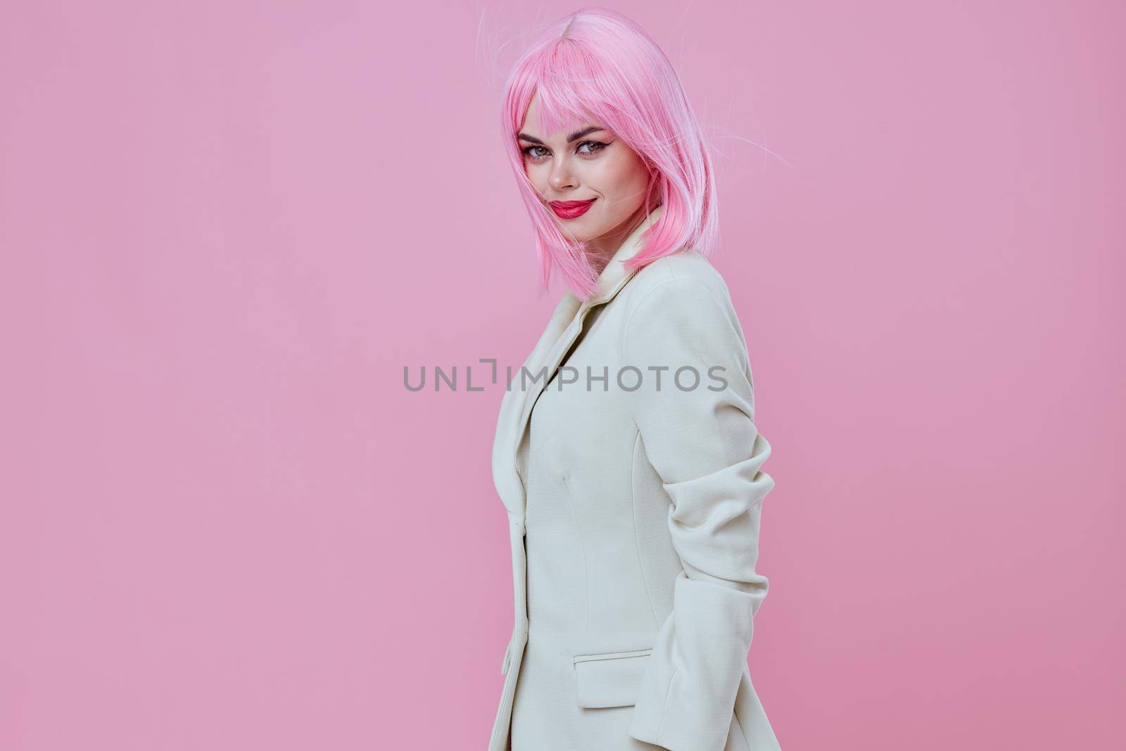 Portrait of a charming lady modern style pink hair Red lips fashion studio model unaltered. High quality photo