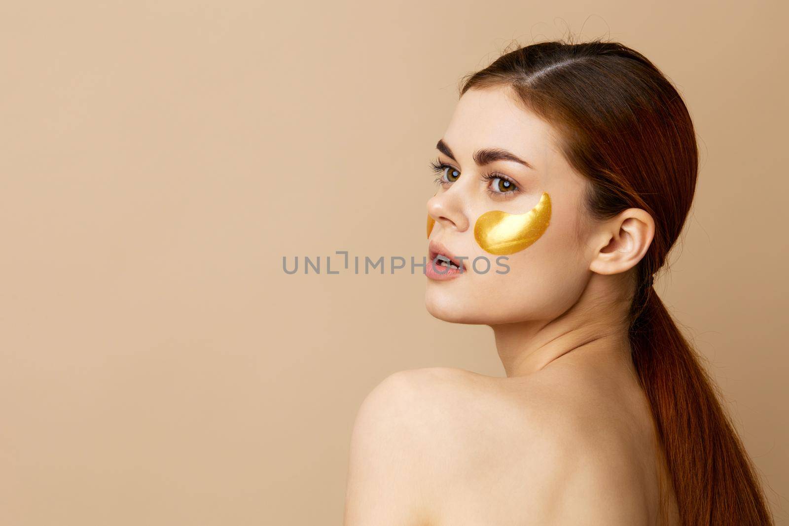 pretty woman golden patches on the face isolated background. High quality photo