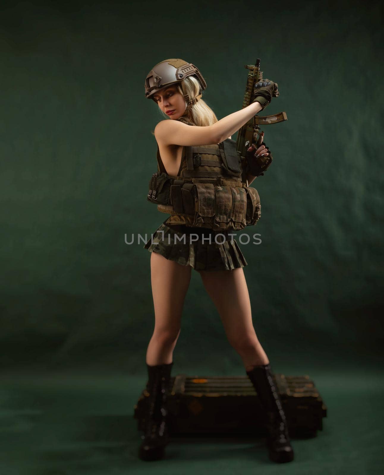 a girl soldier armed with an automatic rifle in military clothes on a green background by Rotozey