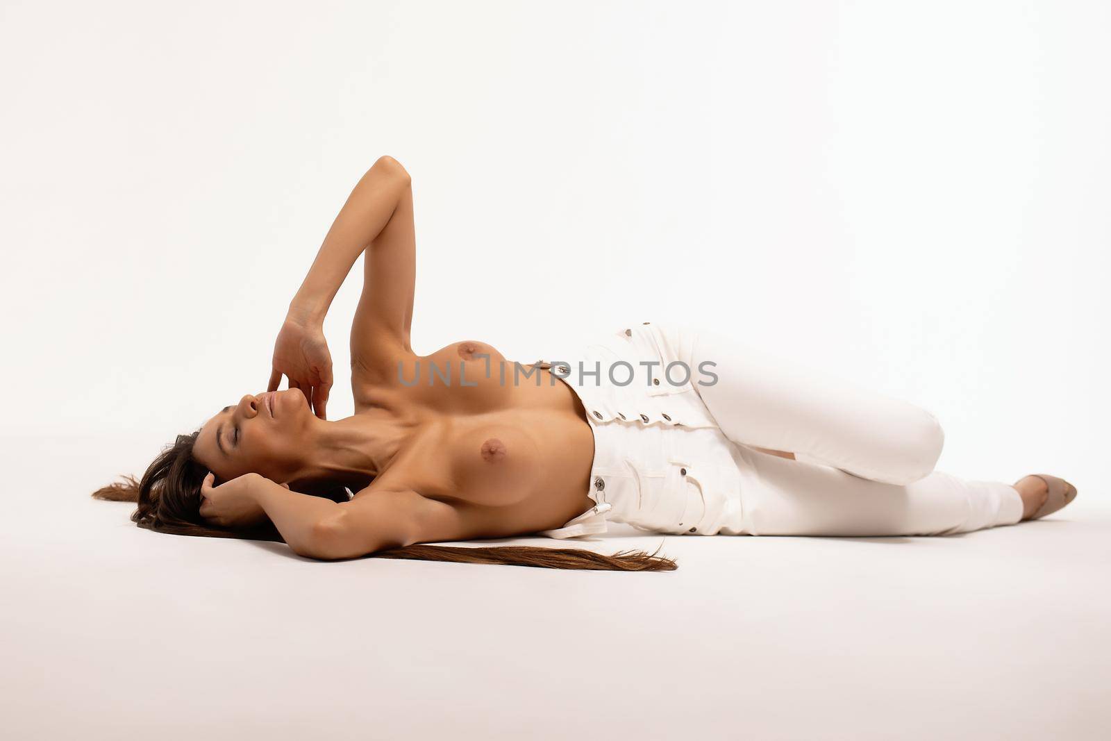 Topless woman lying on floor by 3KStudio