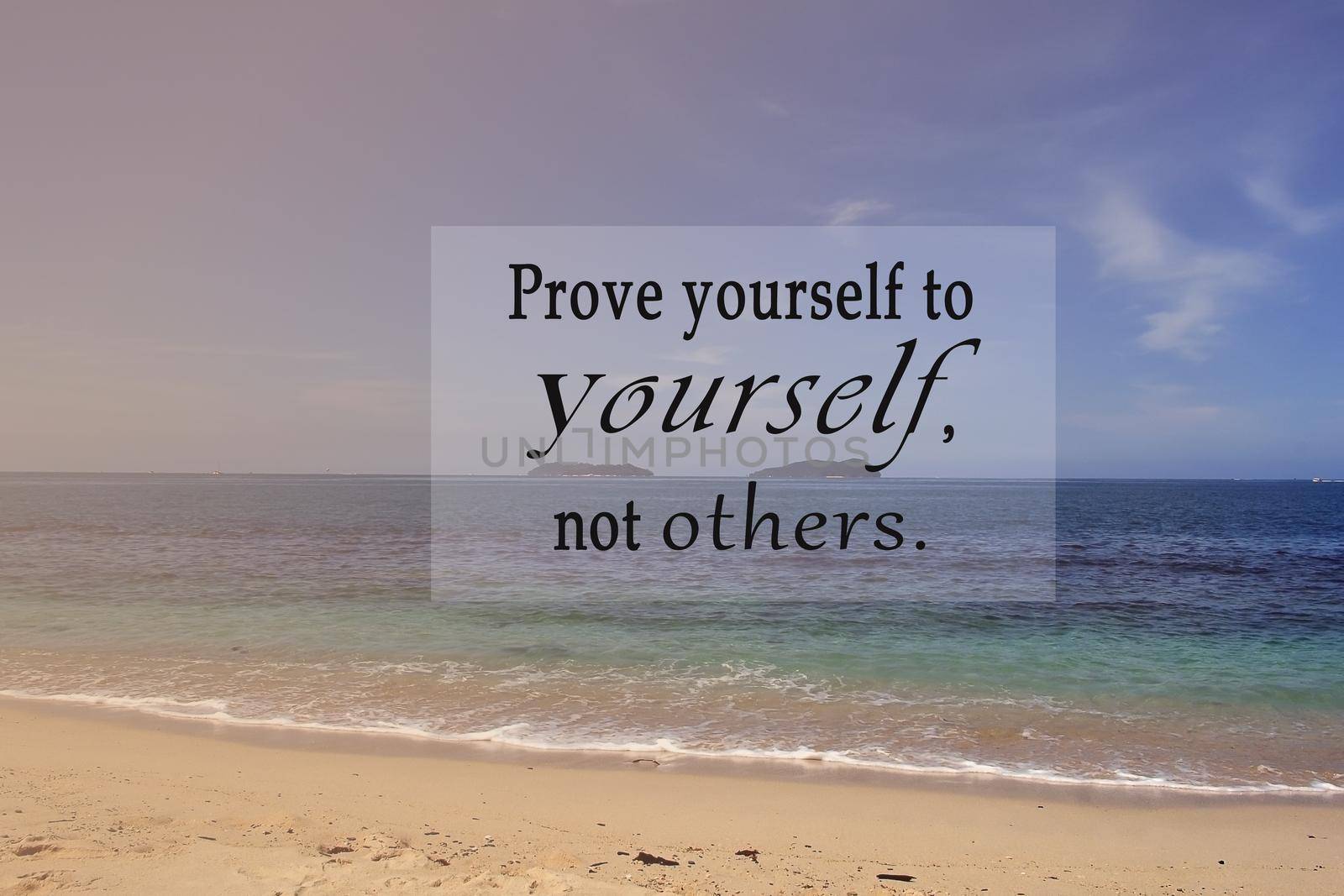 Motivational and inspirational quote on blurred background of blue ocean - Prove yourself to yourself, not others.