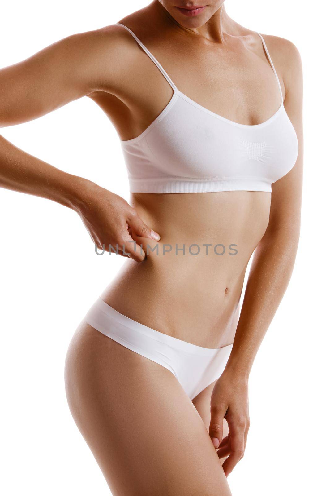 Young body of girl in white underwear, showing fat on her side, posing isolated on white. Plastic surgery, aesthetic cosmetology concept. Close-up. by nazarovsergey