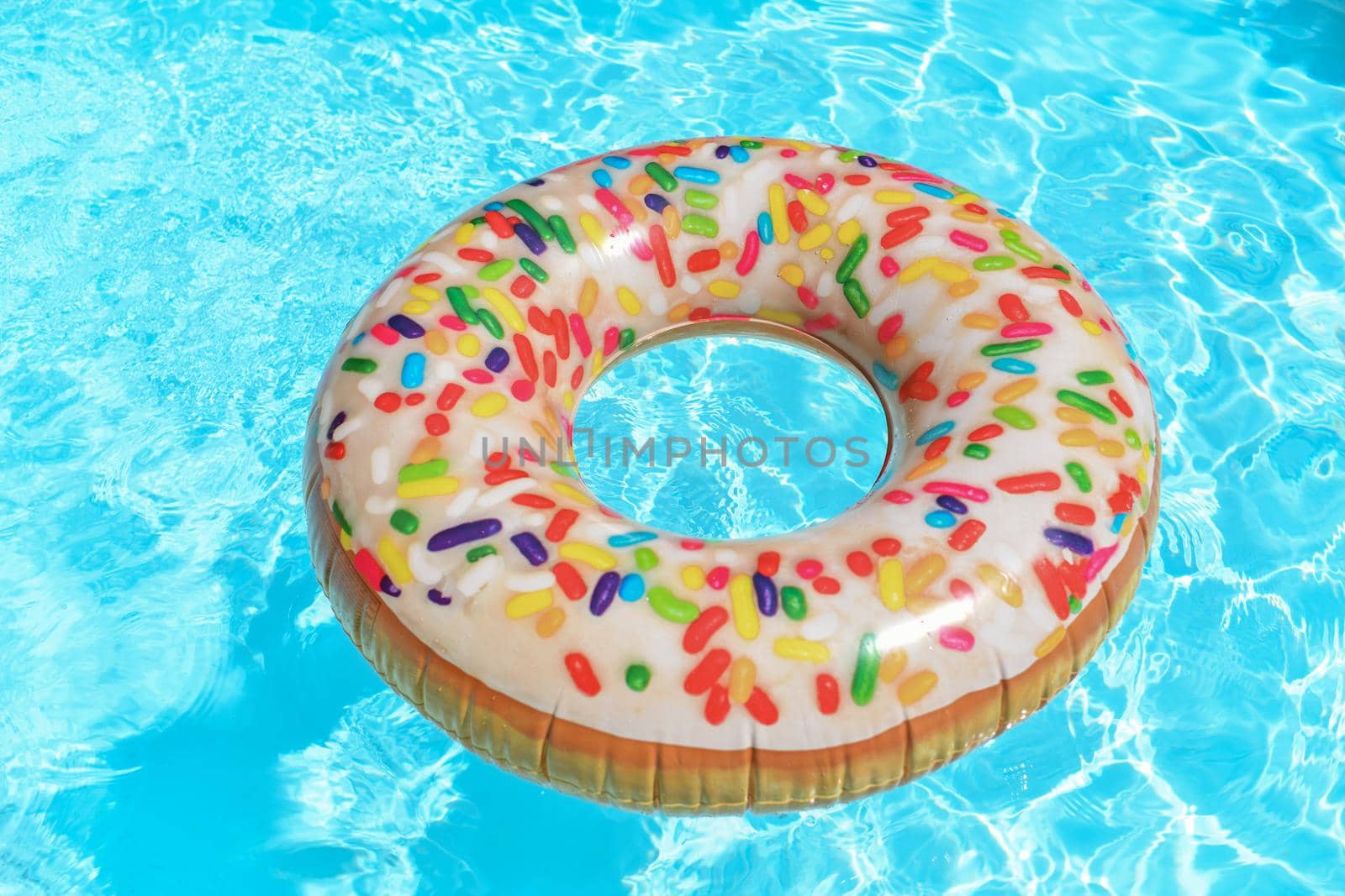 Inflatable circle donut floats at swimming pool.