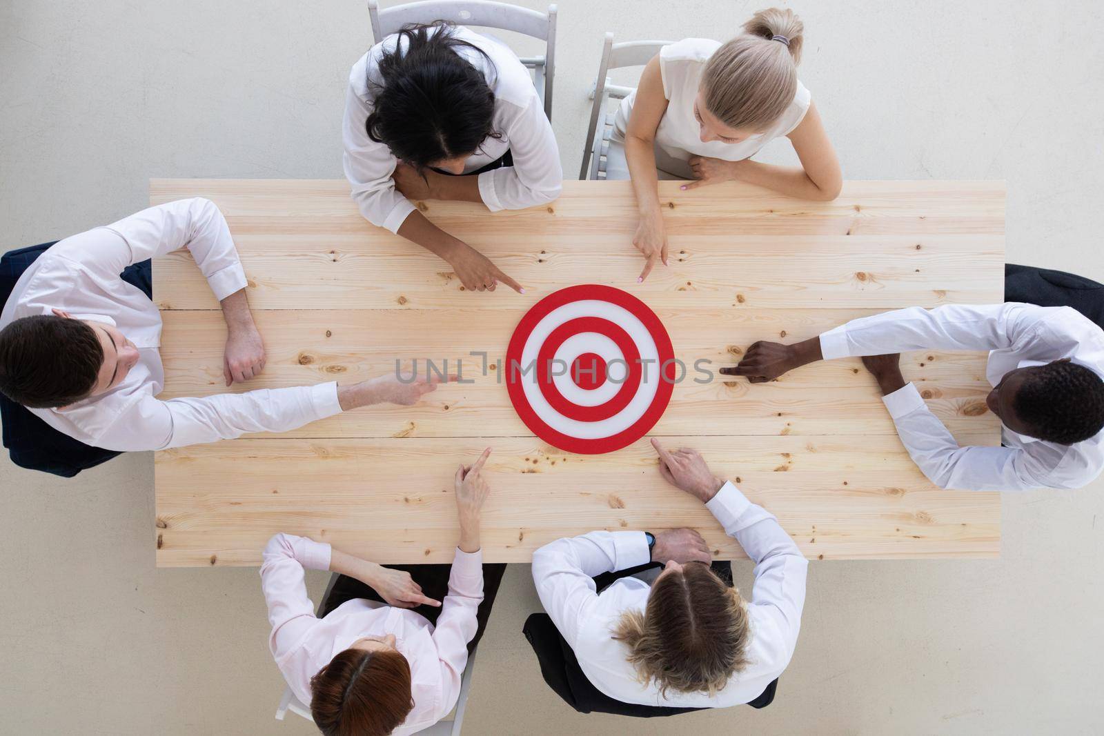 Business team pointing at target by ALotOfPeople