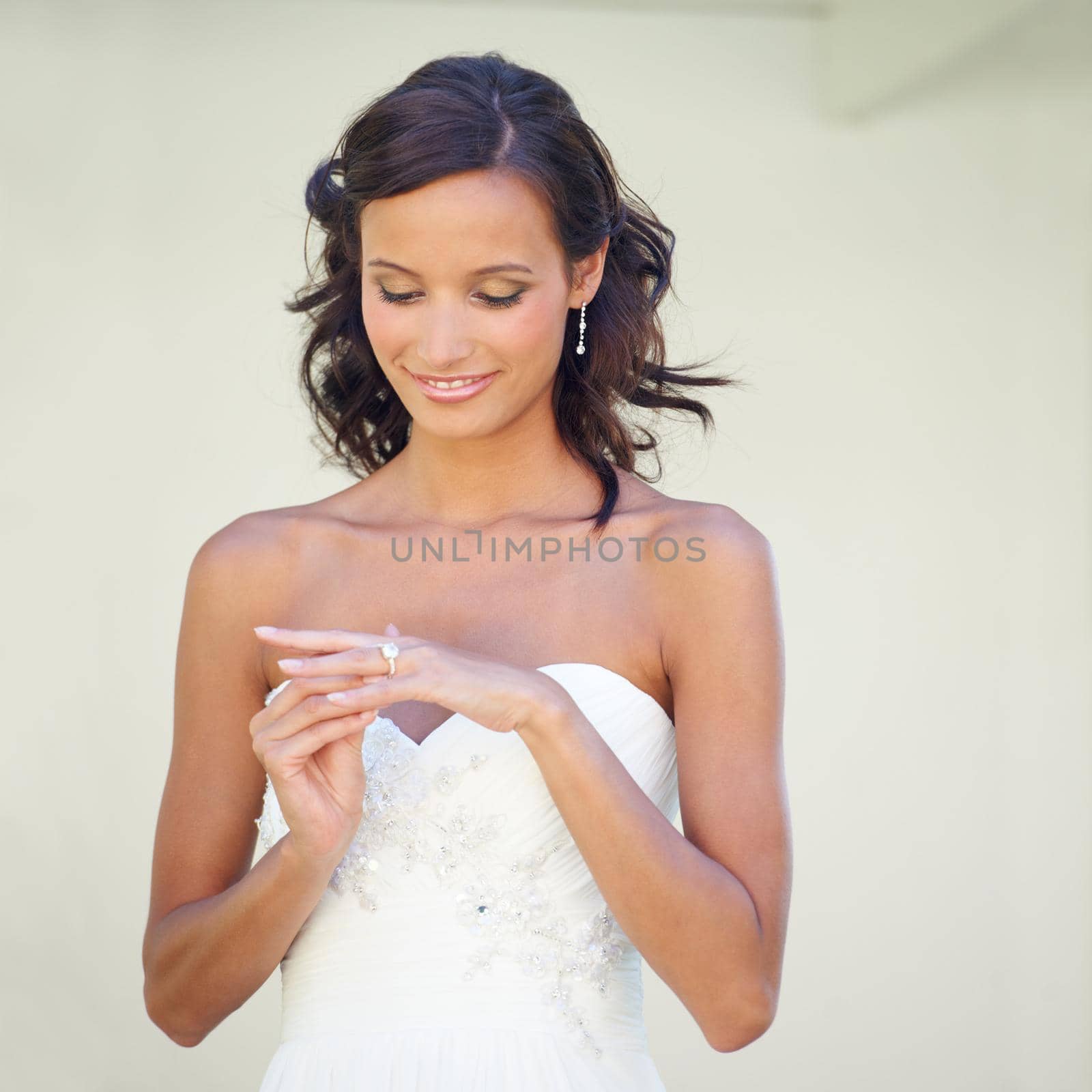 Her favorite piece of jewelry. A young bride looking at her wedding ring. by YuriArcurs