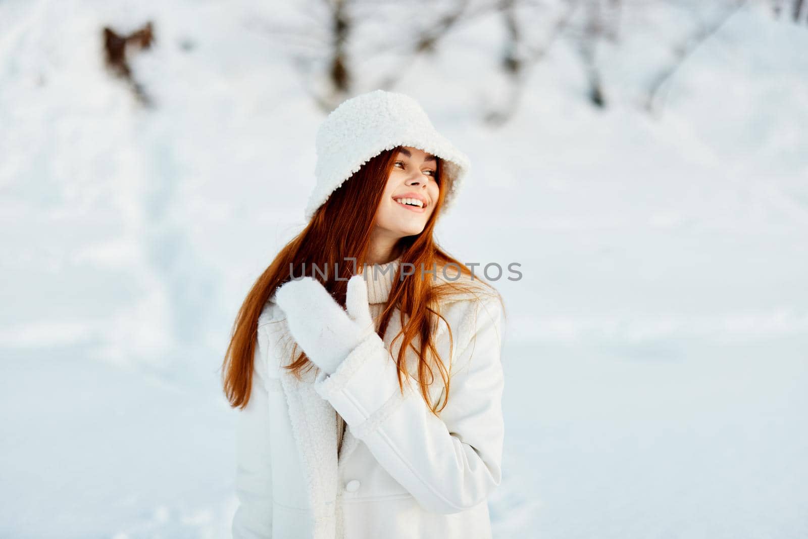 woman in a white coat in a hat winter landscape walk Lifestyle. High quality photo