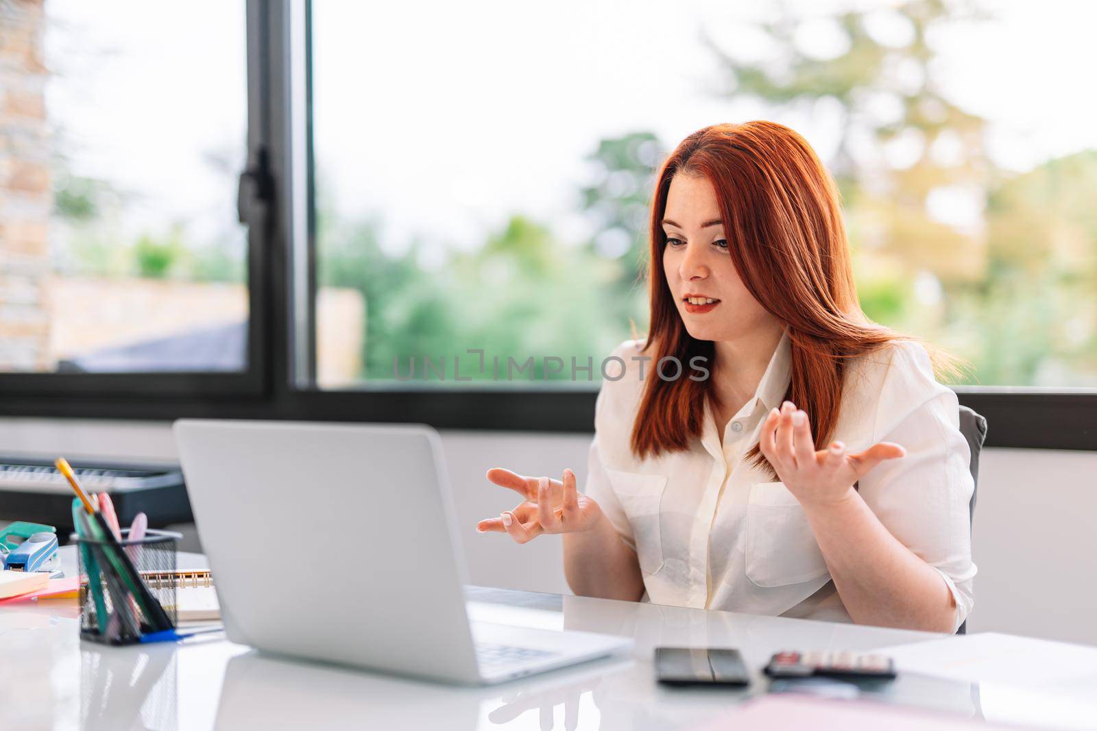 Young girl in a video conference at work by CatPhotography