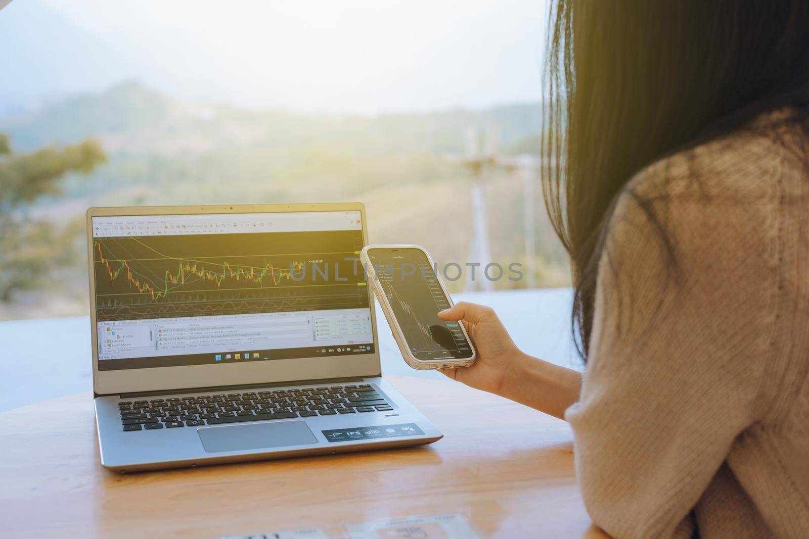 Woman is checking Bitcoin price chart on digital exchange on smartphone, cryptocurrency future price action prediction. by iPixel_Studio