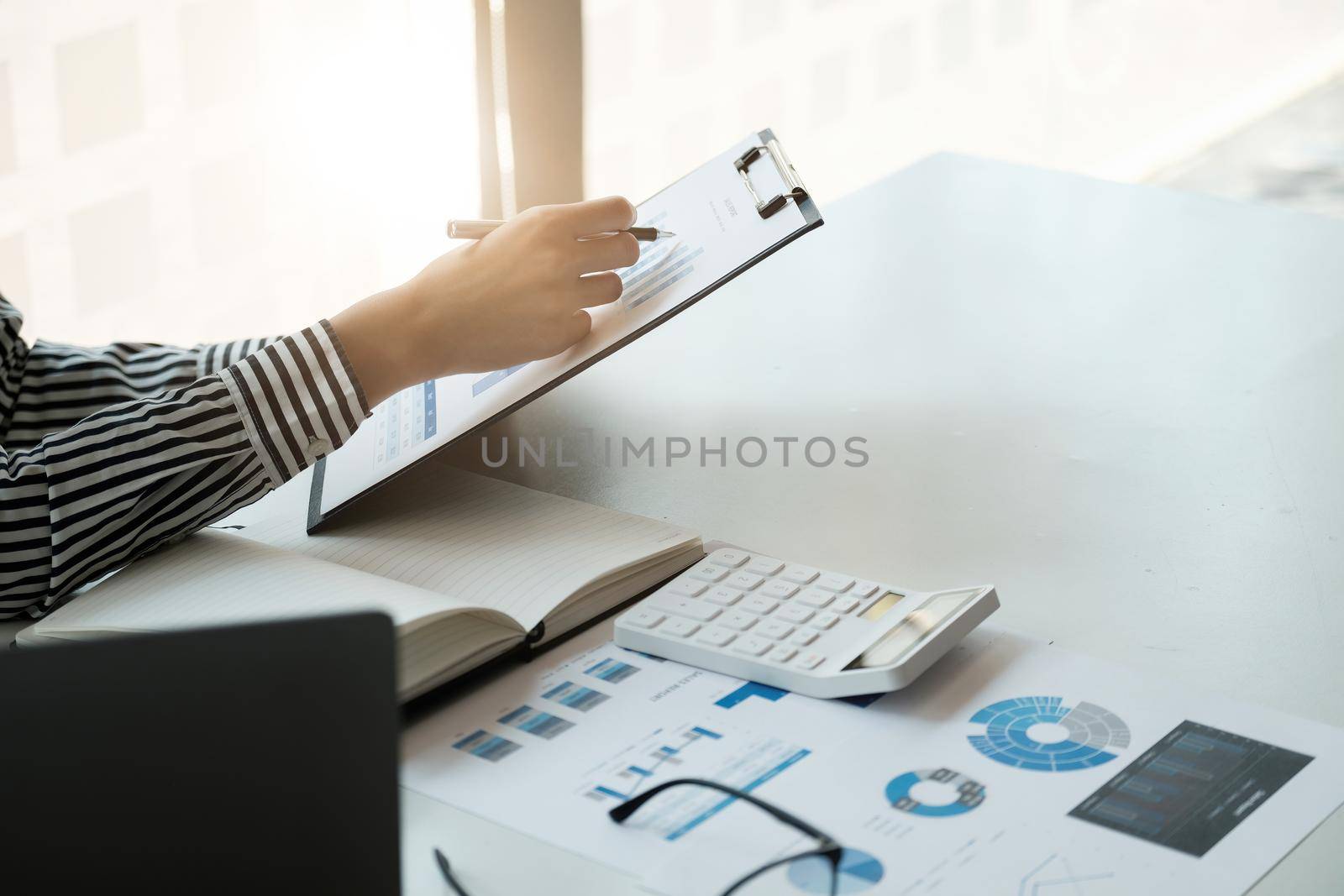 Business accounting concept, Business Man using calculator with computer laptop, pen, budget and loan paper in office.