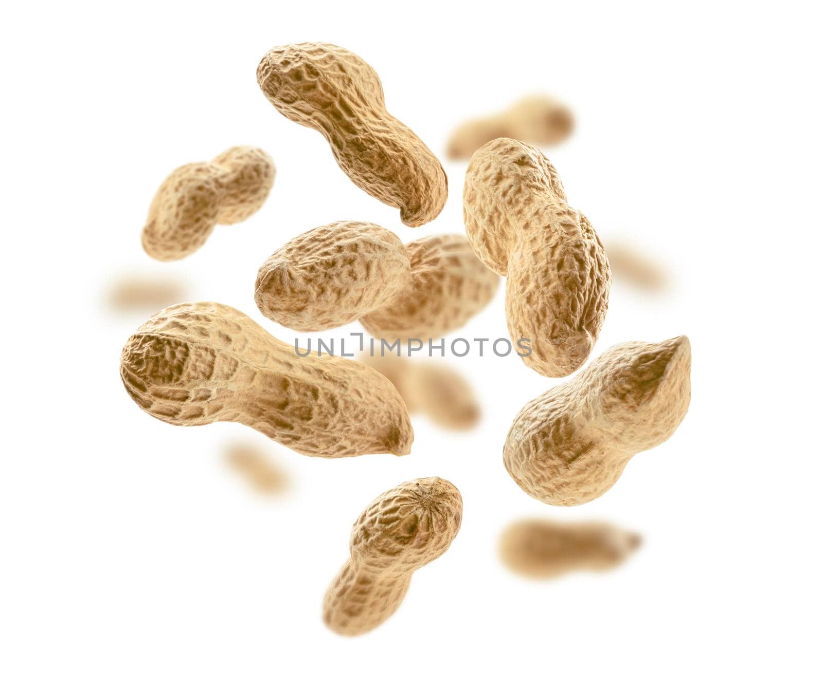Peanuts in the shell levitate on a white background.