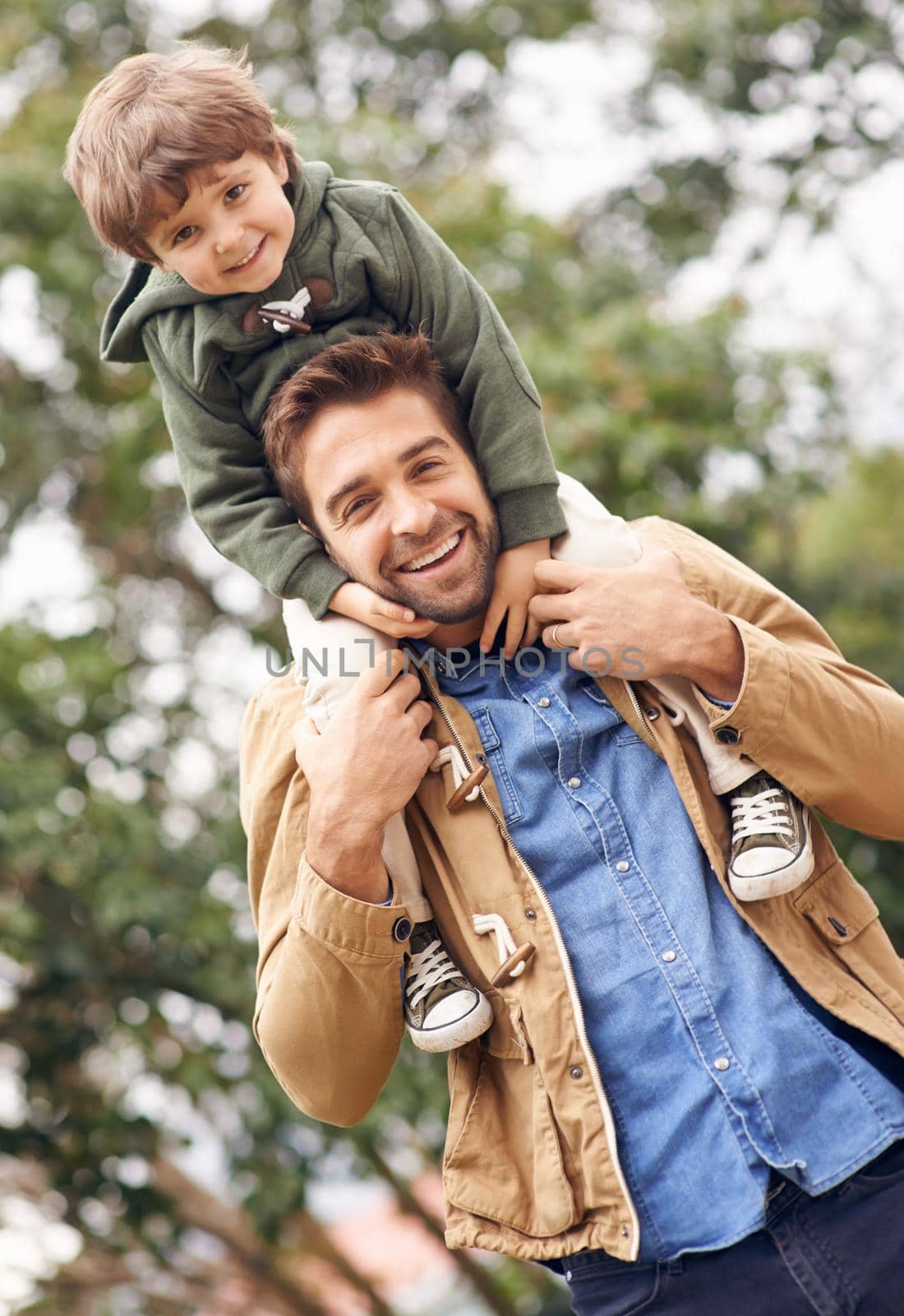 He loves the outdoors as much as I do. Shot of a father and son enjoying a day outdoors. by YuriArcurs