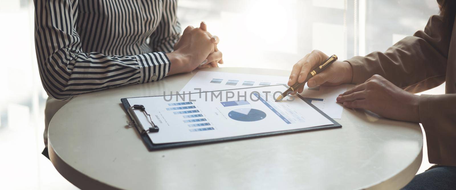 Financial Business team present. Business man hands hold documents with financial statistic stock photo, discussion, and analysis report data the charts and graphs. Finance Financial concept. by nateemee