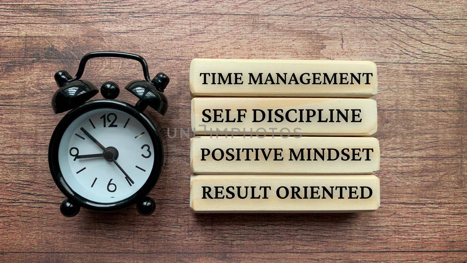 Wooden blocks with text - Time management, self discipline, positive mindset, result oriented.