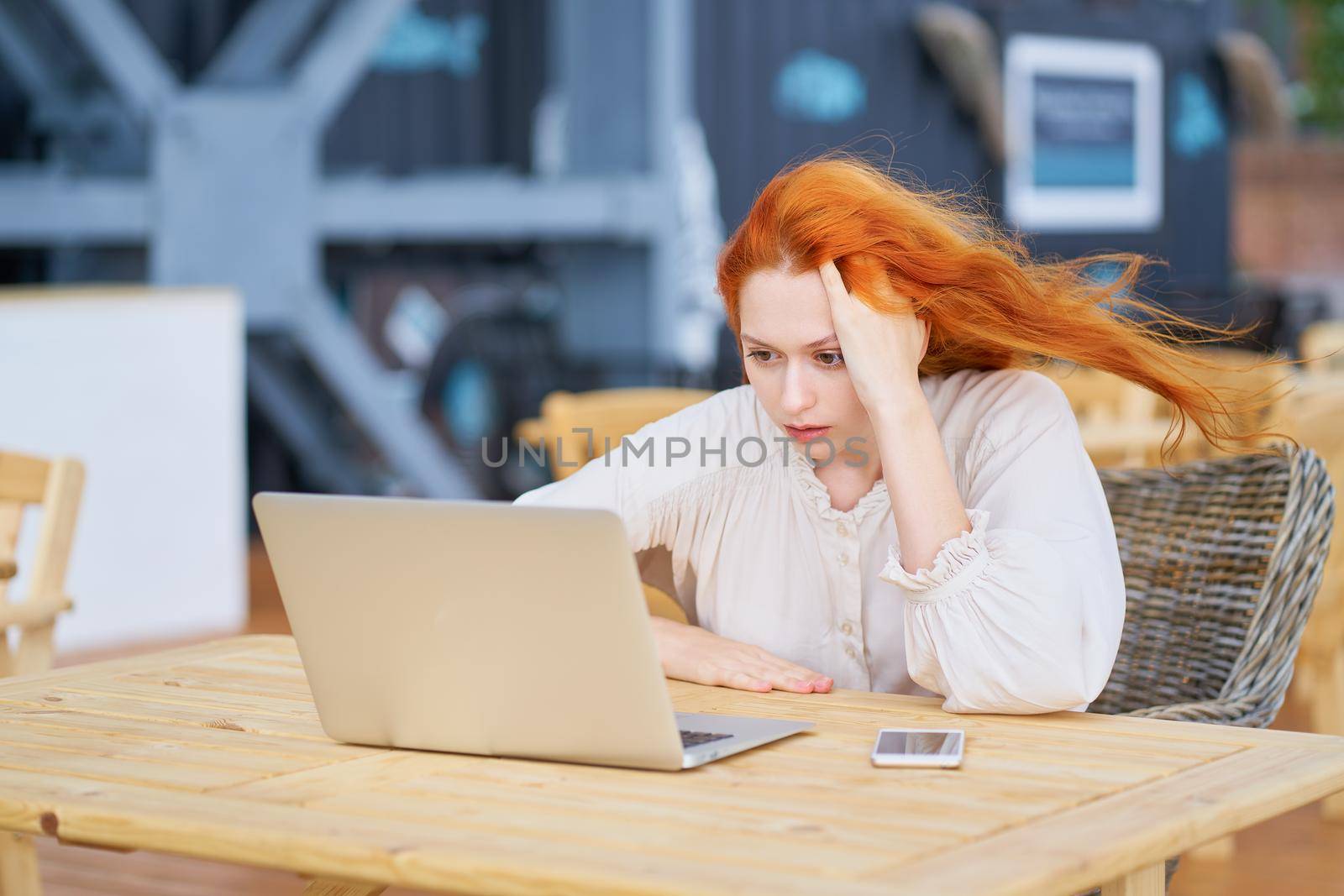 Coronavirus outbreak. Woman reading news about coronavirus and getting anxiety by NataBene