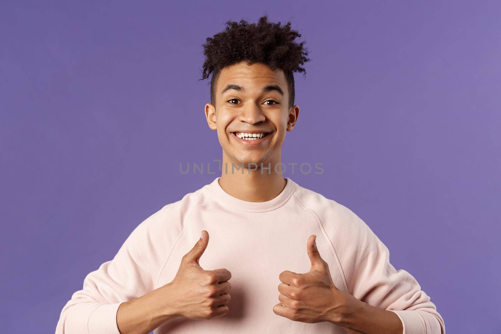 Close-up portrait of enthusiastic handsome young teenage guy, college student recommend awesome courses, online education school, show thumbs-up as recommending, like and approve, smiling by Benzoix