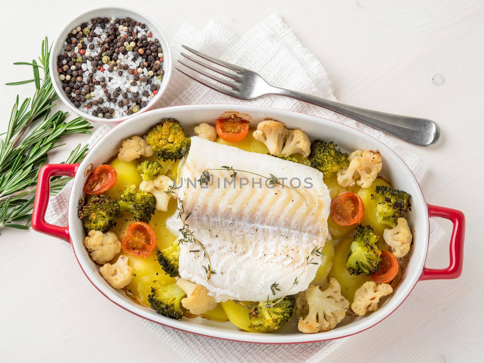 Fish cod baked in the oven with vegetables - healthy diet healthy food. Light white wooden background, top view. by NataBene