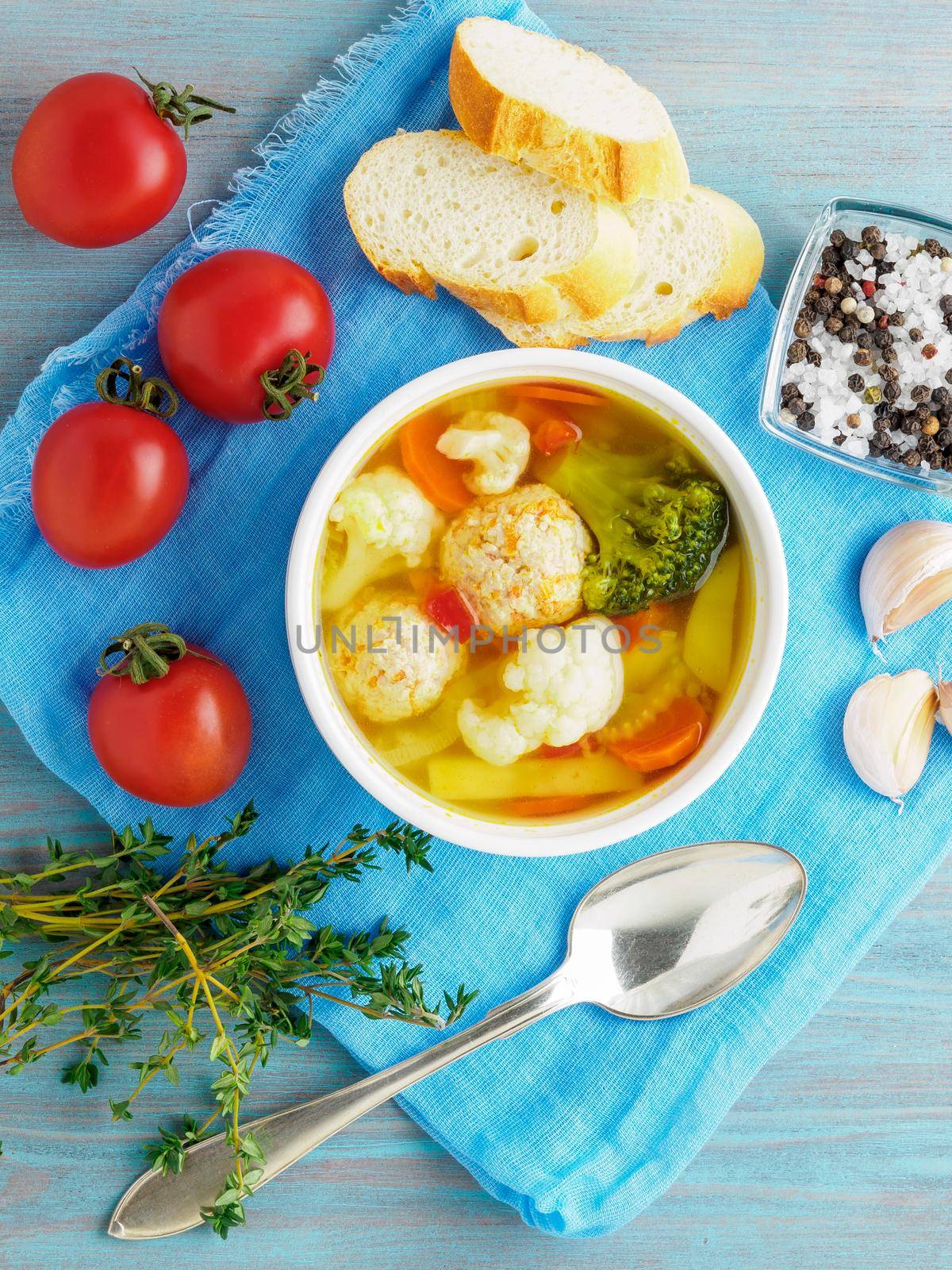 Delicious, thick Soup with Turkey meatballs and mixed vegetables - cauliflower, broccoli, carrots, potatoes, garlic, tomatoes. Copy space, top view