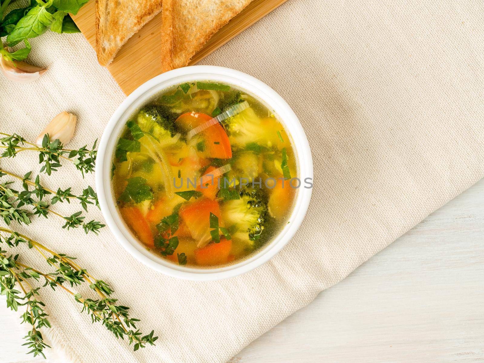 Delicious thick Soup with mixed vegetables - cauliflower, broccoli, carrots, potatoes, garlic, tomatoes. Healthy diet food. Top view, copy space for text
