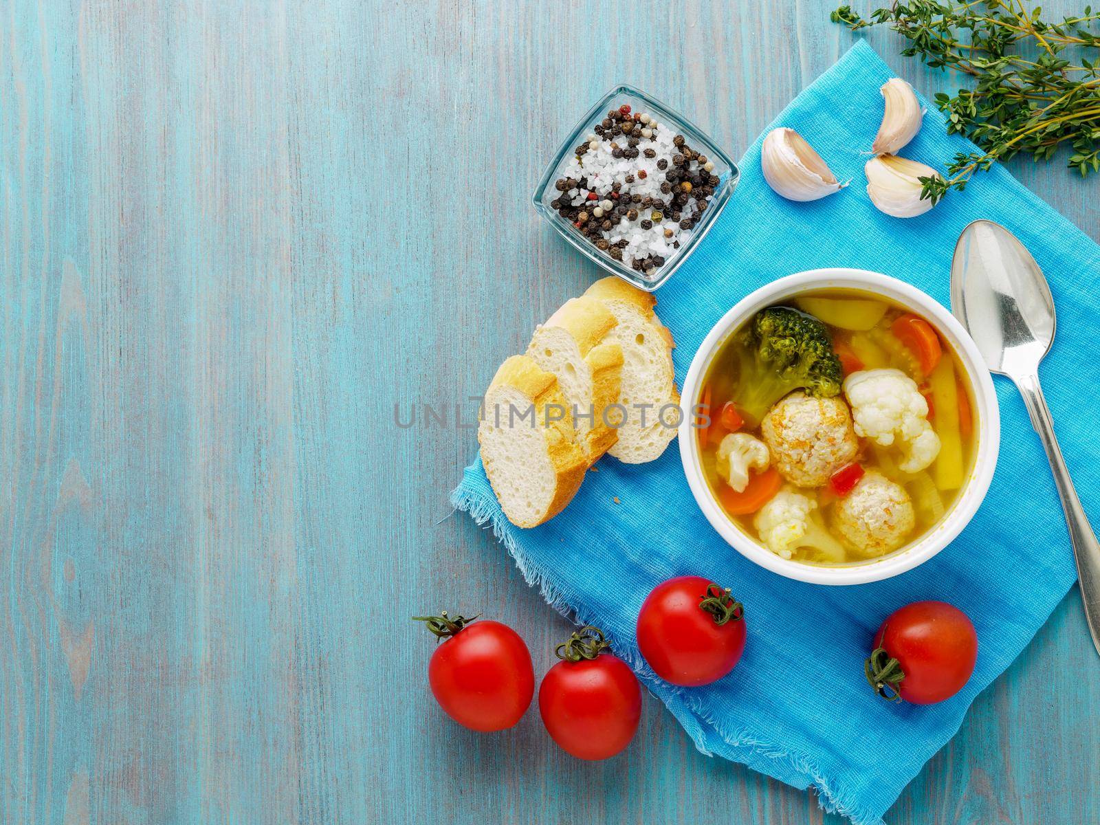 Delicious, thick Soup with Turkey meatballs and mixed vegetables - cauliflower, broccoli, carrots, potatoes, garlic, tomatoes. Copy space, top view