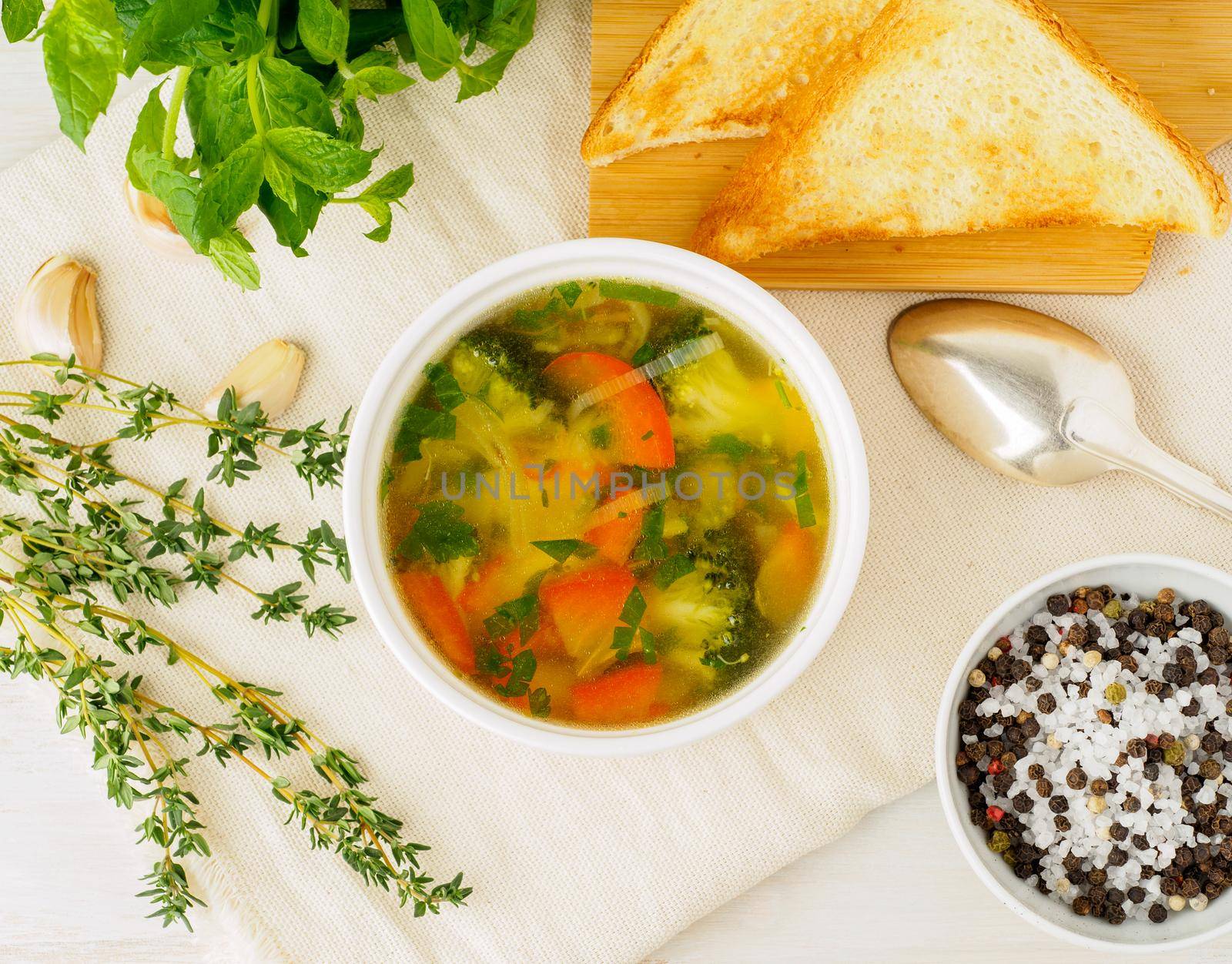 Delicious thick Soup with mixed vegetables - cauliflower, broccoli, carrots, potatoes, garlic, tomatoes. Healthy diet food. Top view