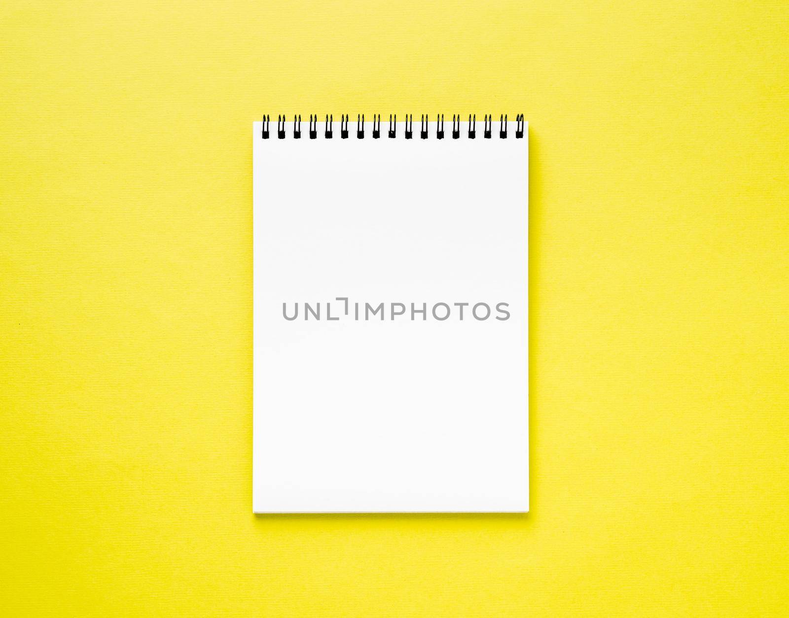 Blank notepad white page on yellow desk, color background. Top view, empty space for text. by NataBene